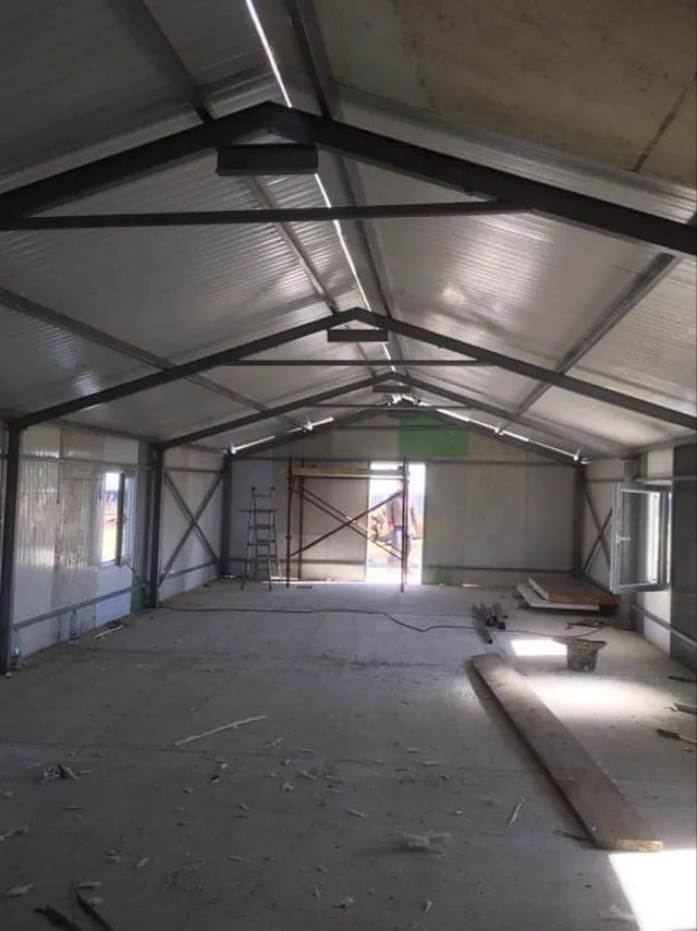 Inside the main building, roof structure visible.