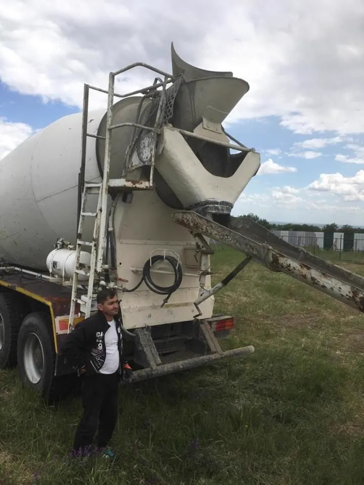 The chute of the concrete mixer pouring.