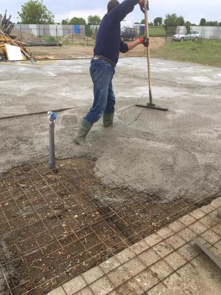 Raking the concrete level.